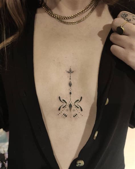 Tattoo between breast: perfect tattoo ideas to。